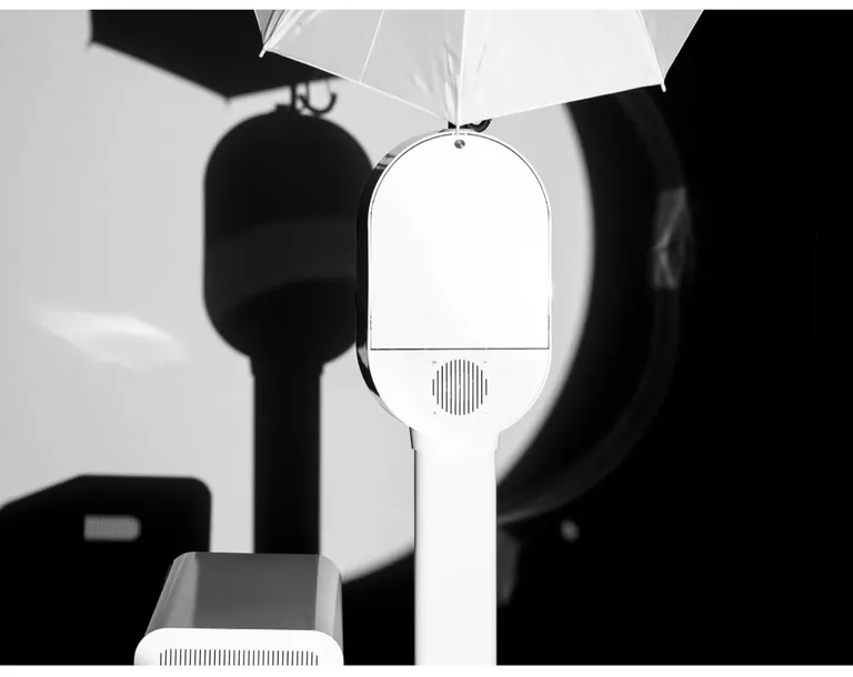 Black-and-white close view of the Studio Booth beneath its umbrella light