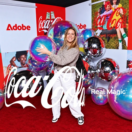 Finished Coca-Cola-branded photo of a guest posing with iridescent balloons at the Adobe and Coca-Cola exhibition backdrop