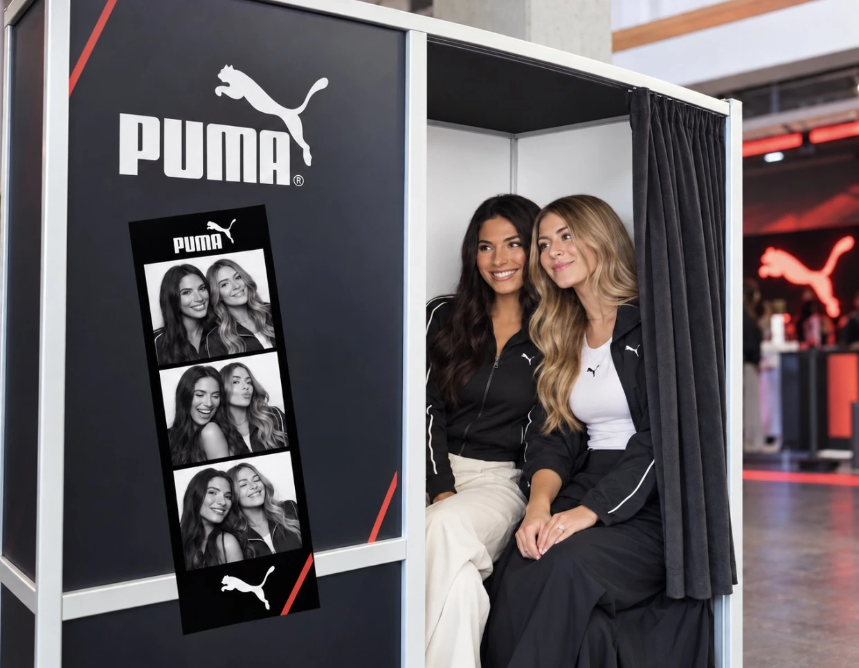 Puma-branded enclosed booth concept with two guests, a large Puma logo and a matching photo strip