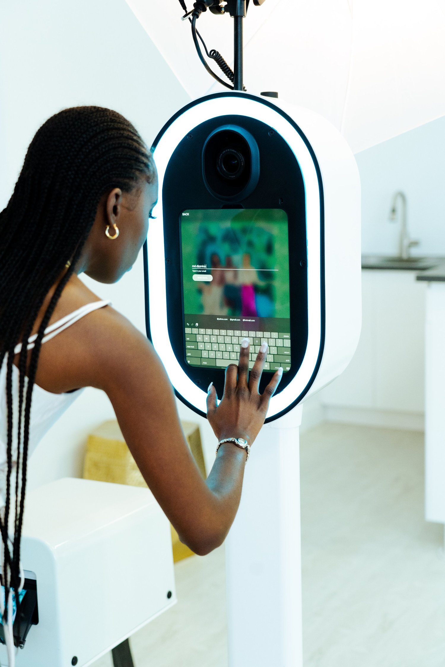 Guest using the white Studio Booth touchscreen